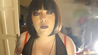 Chubby Dominatrix Tina Smua Puffs On A Unfiltered Cigarette From A Holder